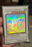 Yugioh Stardust Dragon TDGS-EN040 Ghost Rare Unlimited Edition DAMAGED - See pic