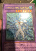 Yugioh Elemental HERO Aqua Neos POTD-EN031 Ultimate Ra Gold Stamp NA HP (CREASE)