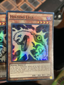 Yugioh Holding Legs MIL1-EN004 Super Rare 1st Edition HP/MP